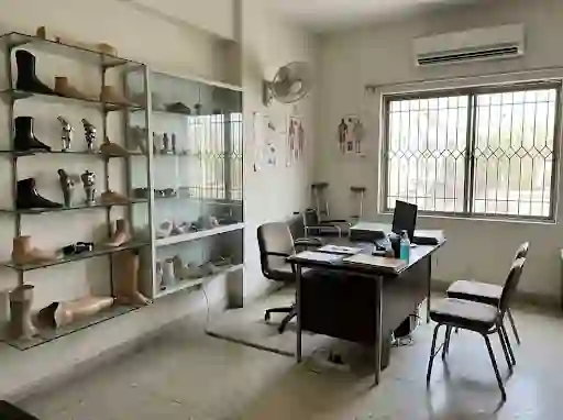 Clinic consultation area with prosthetic parts on shelves