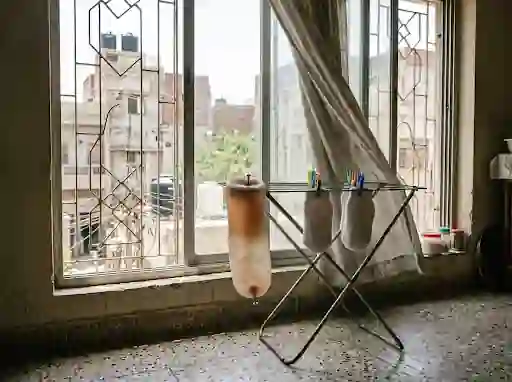 Liner and stump socks drying by an open window