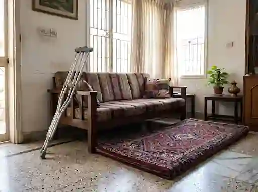 Floor mat beside a low sofa with crutches