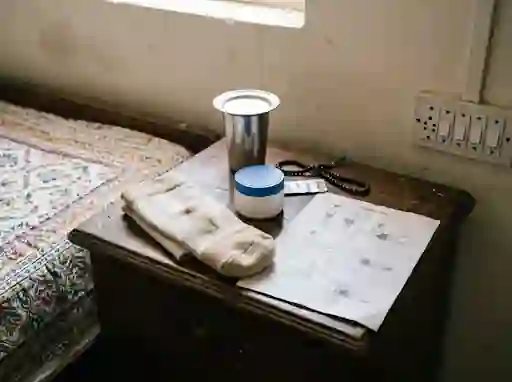 Stump shrinker, moisturiser and an exercise sheet on a bedside table