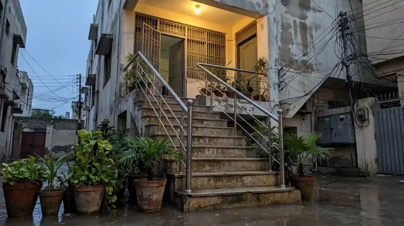 Wet outdoor staircase with a handrail after rain