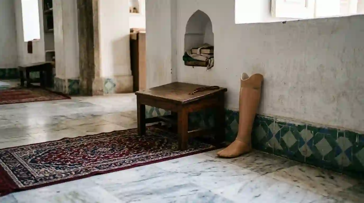 Low prayer stool beside a woven prayer mat