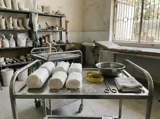 Plaster bandage rolls and a tape measure on a casting trolley